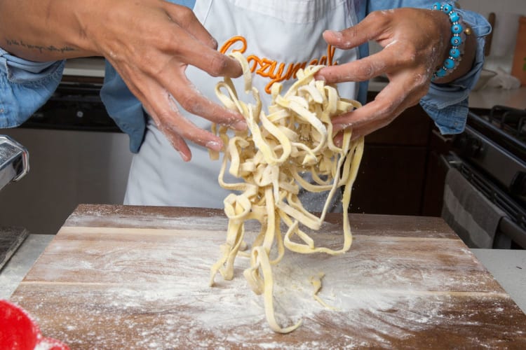 A chef tossing homemade pasta.