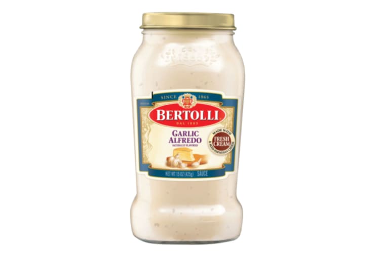 A jar of white pasta sauce.