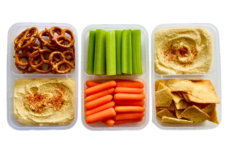Pots of hummus, veggies and pretzels.