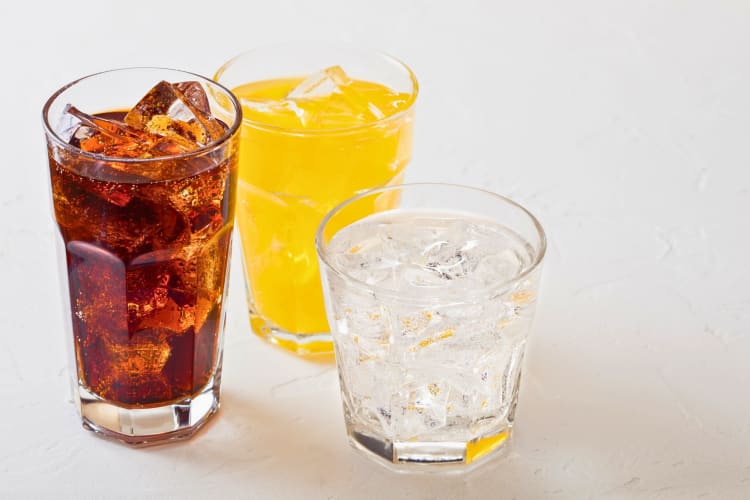 Three glasses of healthy soda alternatives.