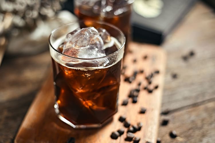 Iced americano coffee with coffee beans.