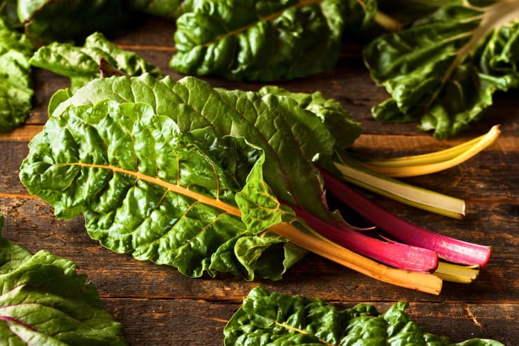 Swiss chard on a wooden surface.