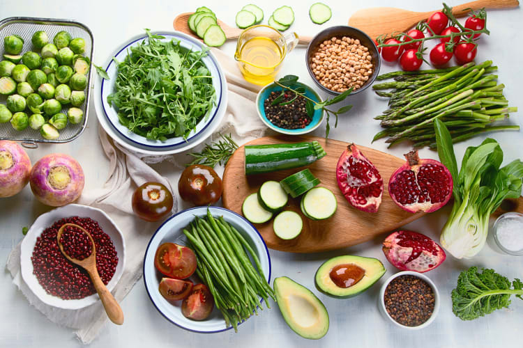 An assortment of vegetables, legumes and fruit on a table