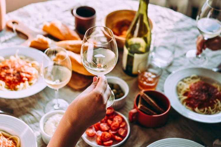 People drinking wine with dinner.