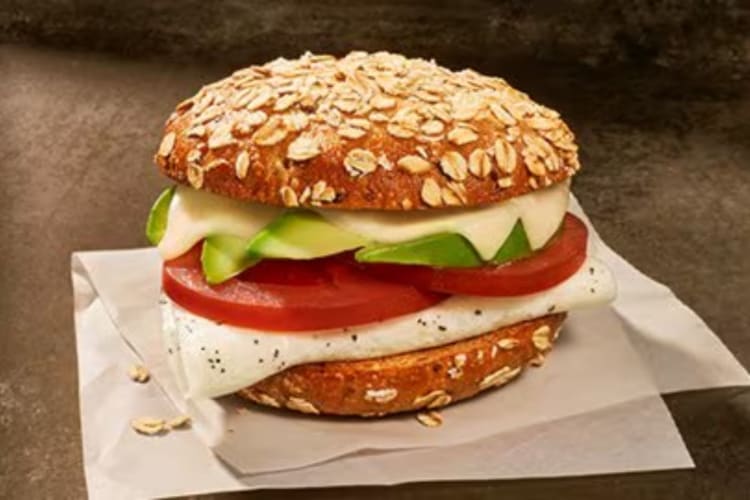 Multigrain Bagel Flat filled with egg and avocado is a healthy fast food breakfast option.