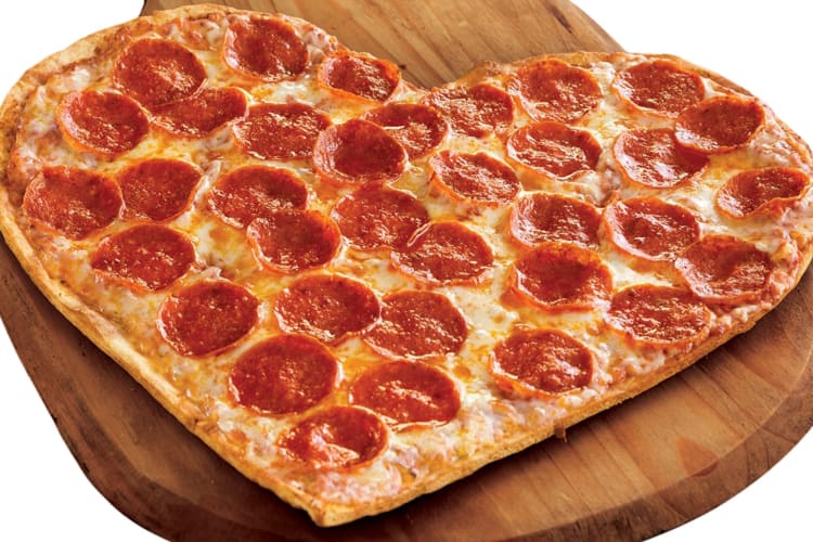 A pizza in the shape of a heart.