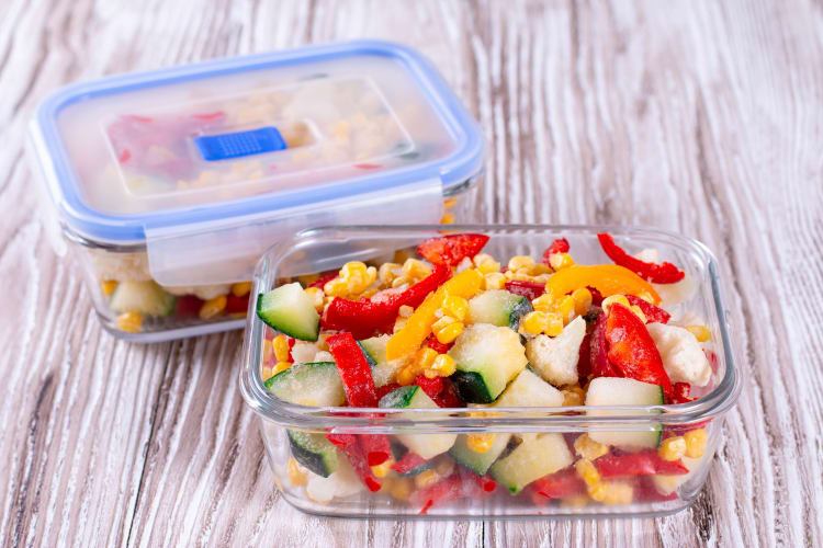 Mixed frozen vegetables in a tupperware container.