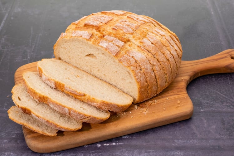 Sliced sourdough bread on a chopping board.