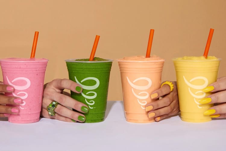 Four hands holding four different Jamba Juice drinks