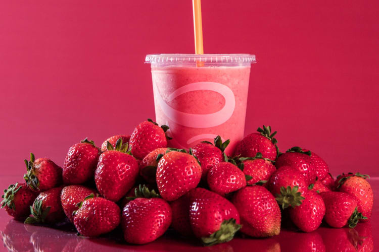 Strawberry smoothie with some fresh strawberries