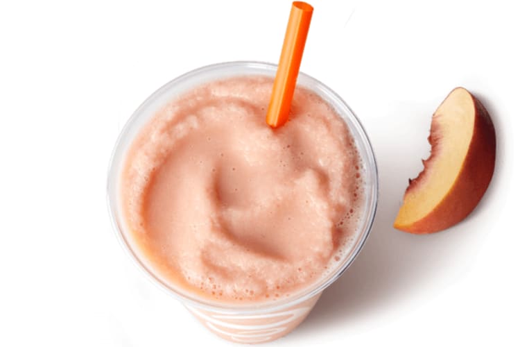 Peach Jamba Juice smoothie with a slice of peach