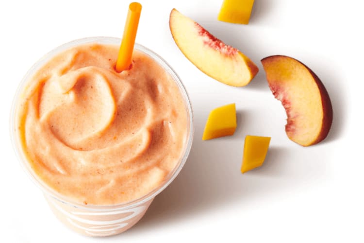 Peach smoothie with some peaches slices