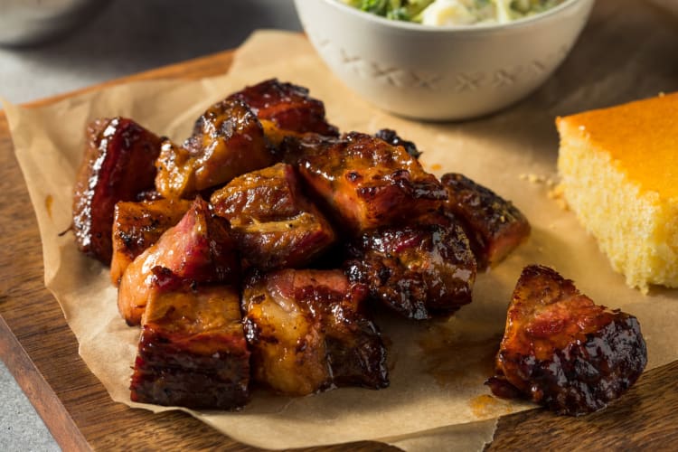 Slow smoked pork burnt ends barbecue with two sides