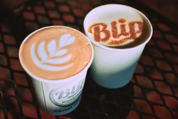 Two lattes with decoration in a to-go cup