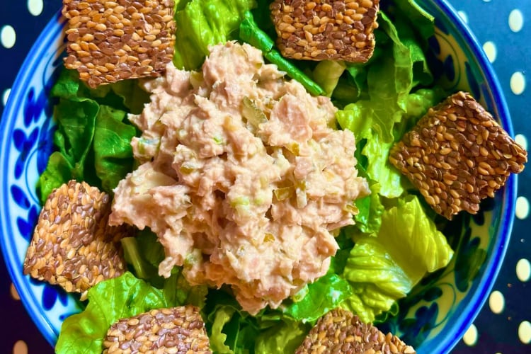A salad topped with keto crackers.