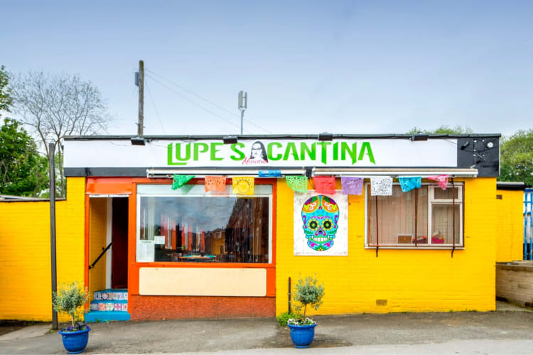 The exterior of a lively and colorful Mexican restaurant in Leeds