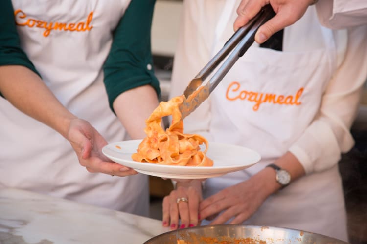 Man serving pasta on a plate