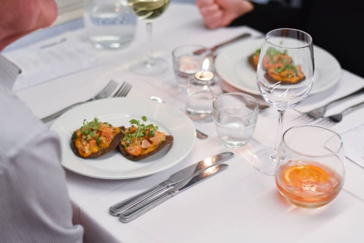 Two diners in a London underground train carriage.