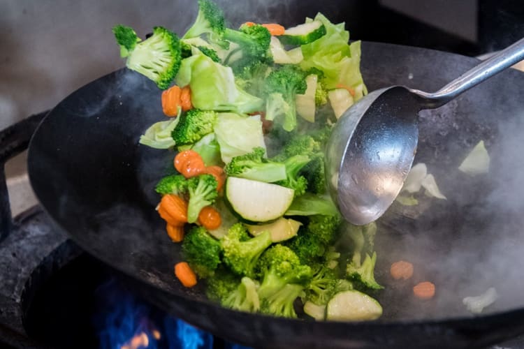 Freshly cut and wok-tossed Mixed Veggies in a wok.