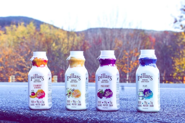 Four bottles of Pillars Drinkable Greek Yogurt on a road