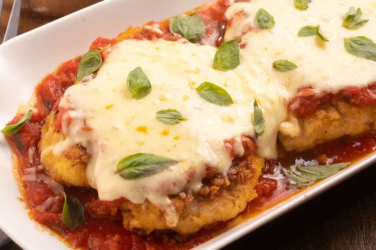 A plate with chicken Parmesan on.