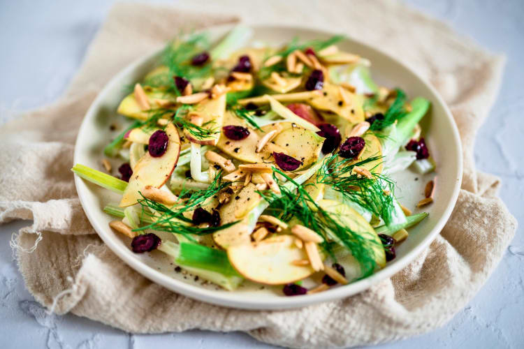 Sliced fruits and vegetable salad in a ceramic plate.