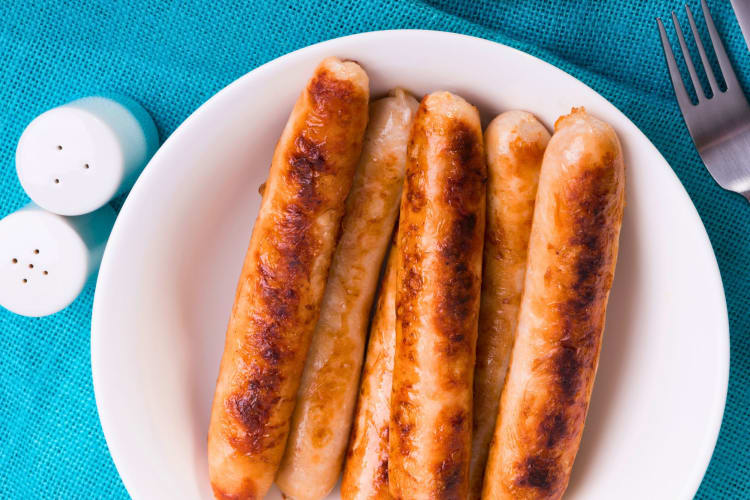 Chicken sausages on a plate.