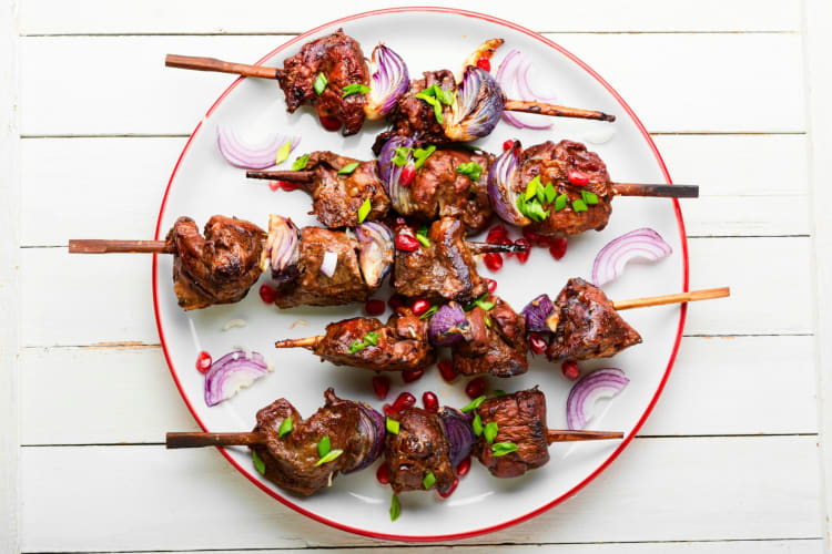 A plate of grilled beef kebabs.