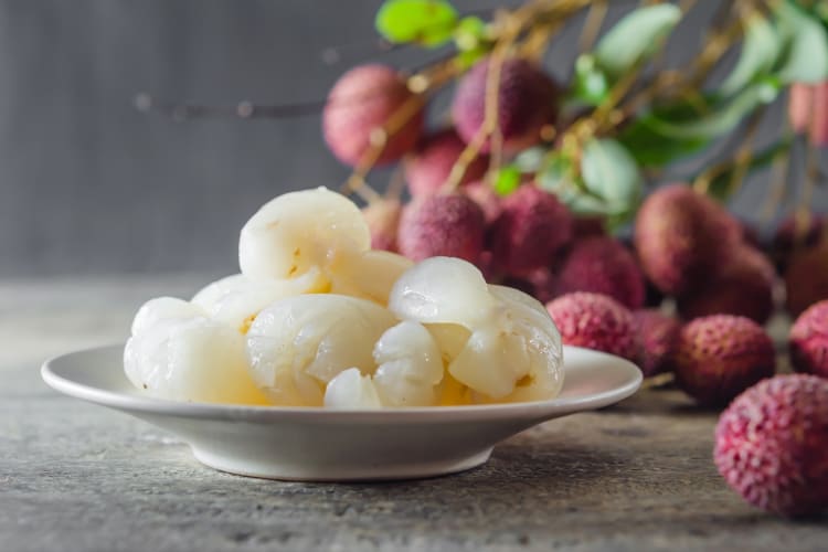 Peeled lychess on a ceramic plate