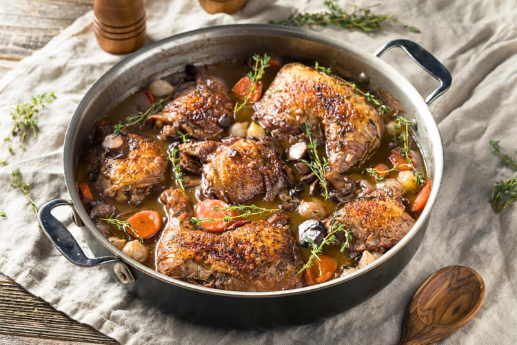 Coq au vin, one of the most delicious Lyon foods, in a pot