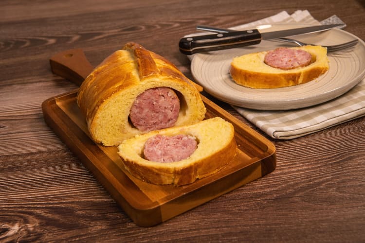 Saucisson brioché, a delicious Lyon food, served on a wooden board and a plate