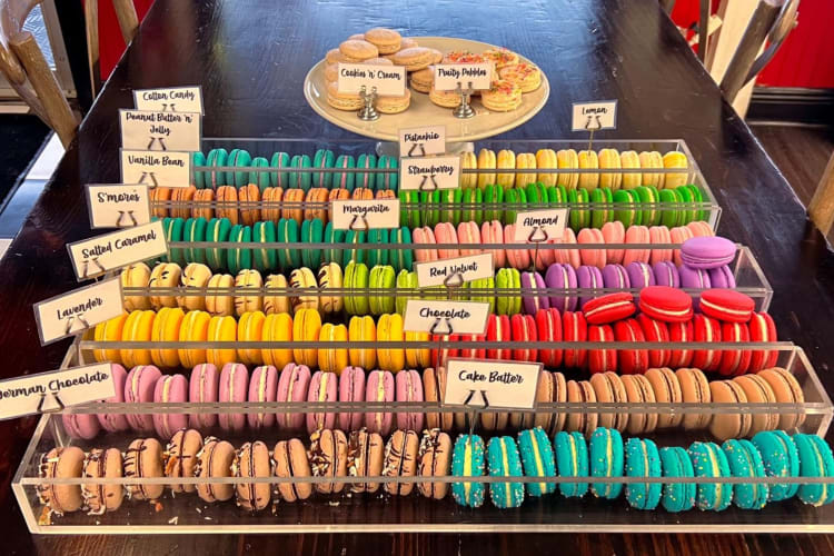 a wide assortment of macarons of different colors with labels