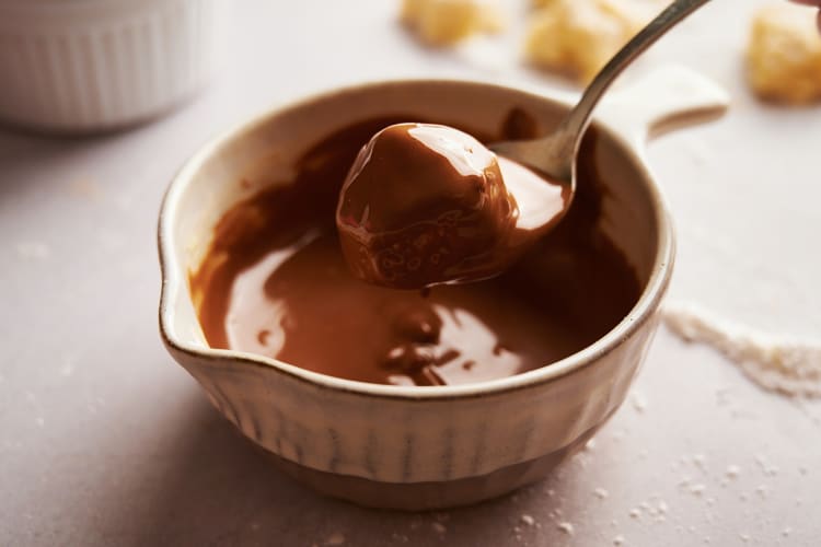 a marzipan ball glistening with chocolate