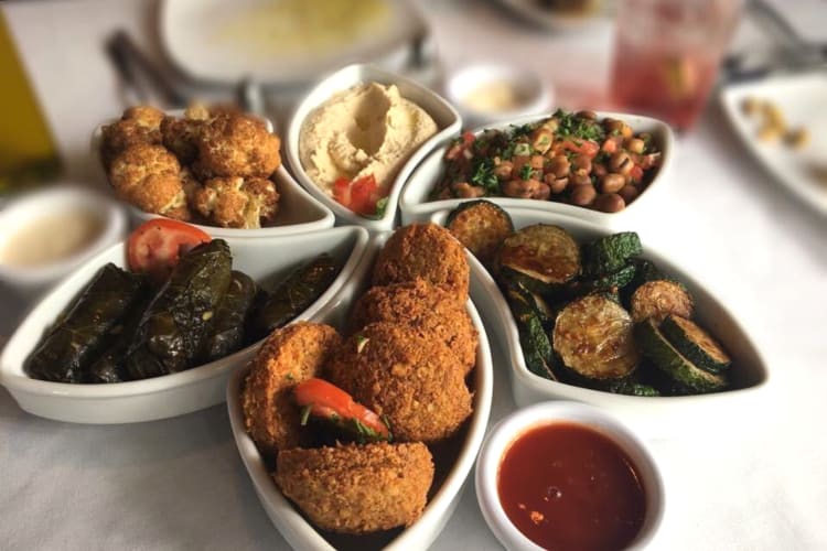 a variety of mezze dishes, including hummus and dolmades