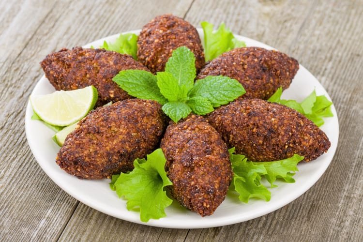 A plate of six kibbehs, which is a tasty Middle Eastern food