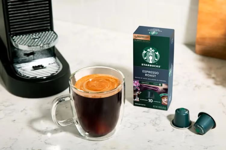 A coffee machine, Espresso Roast box and a Caffè Americano, one of the most caffeinated drinks at Starbucks