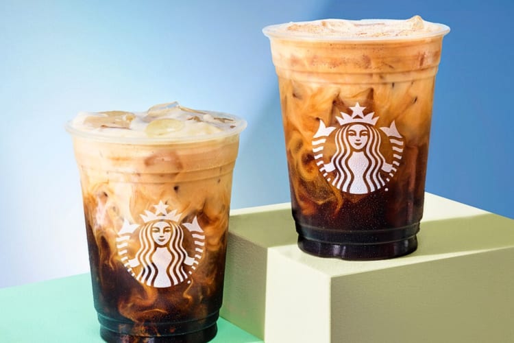 Two of the most caffeinated drinks at Starbucks on platforms in front of a blue background