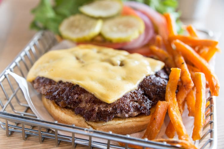 Cheeseburger and sweet potato fries are a savory dish at Nashville restaurantas