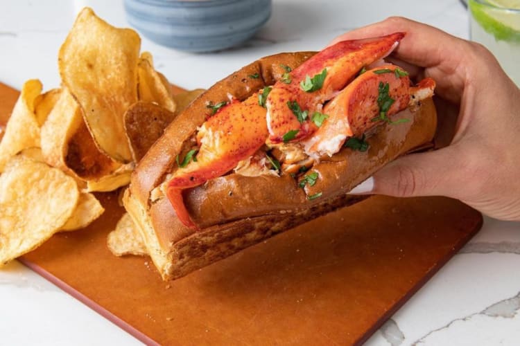 Manhattan style lobster roll served with chips