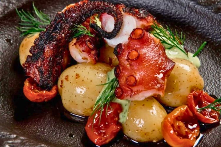 Grilled octopus served with finger potatoes and cherry tomato