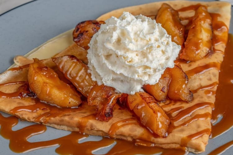 Peach crepe topped caramel drizzle and whipped creamed