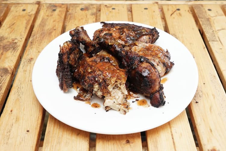 Chicken on a white plate from Peppa's Jerk Chicken