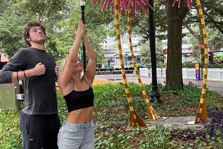 A man and woman posing outside during a scavenger hunt