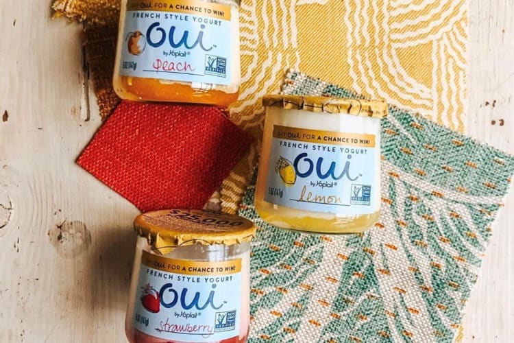 Three jars of Oui yogurts on cloth background