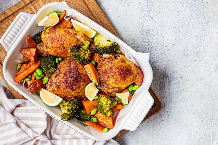 Aerial view of a tray with roast chicken and vegetables — a tasty Passover meal