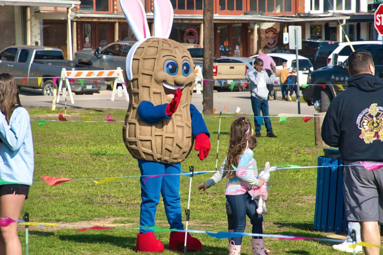 Peanut mascot playing with kids