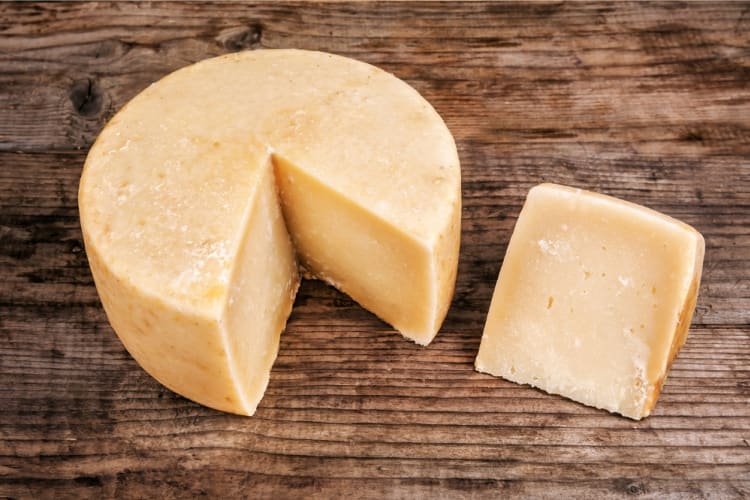 A pecorino cheese with a wedge cut out