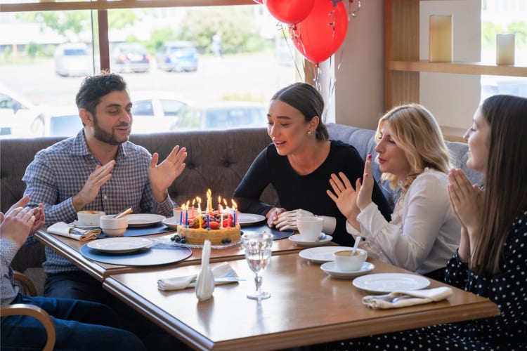 people at a restaurant celebrating a birthday