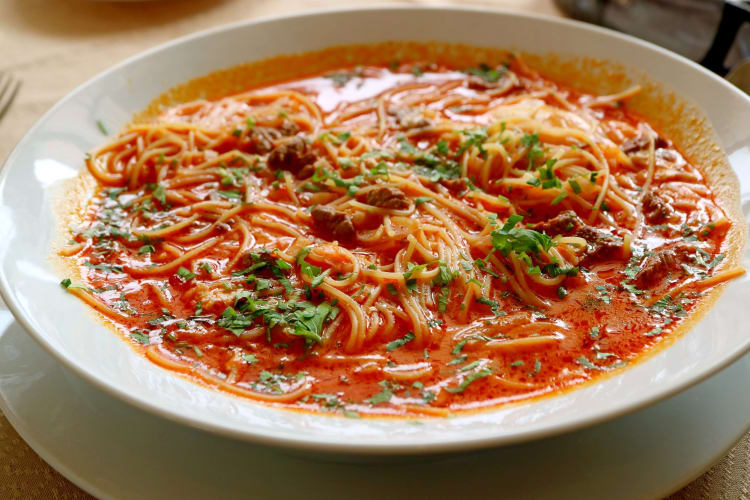 Delicious Peruvian beef noodle soup called sopa Criolla