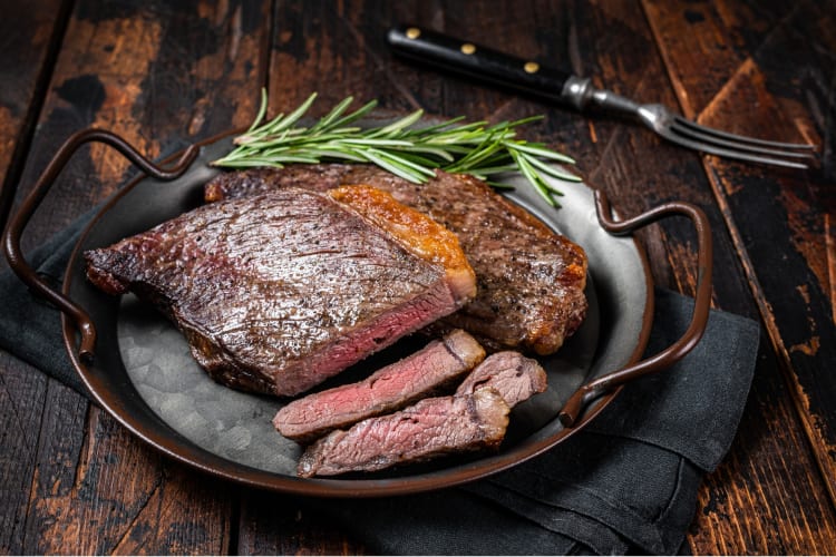 Grilled picanha whole and sliced, served with rosemary 